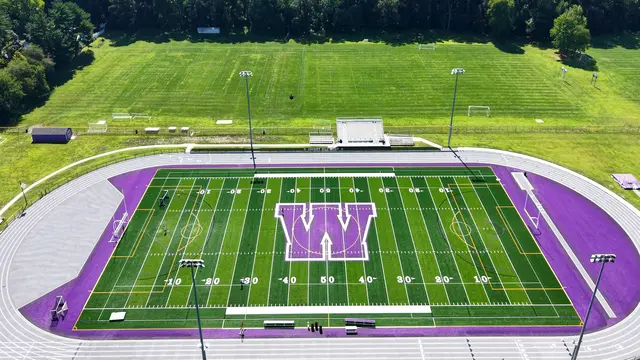 Cherry Hill West’s track and turf field with midfield W logo and stadium lighting