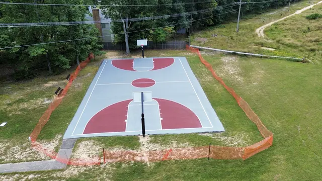 View along Flair Ridge Park basketball court toward the far hoop