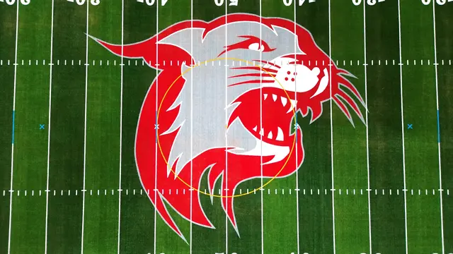 Red and white Wildcat midfield logo on Owen J. Roberts stadium turf