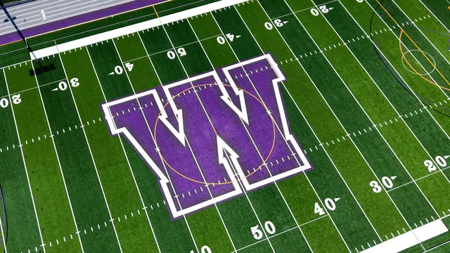 Purple W midfield logo and football markings on Cherry Hill West’s GAME ON turf