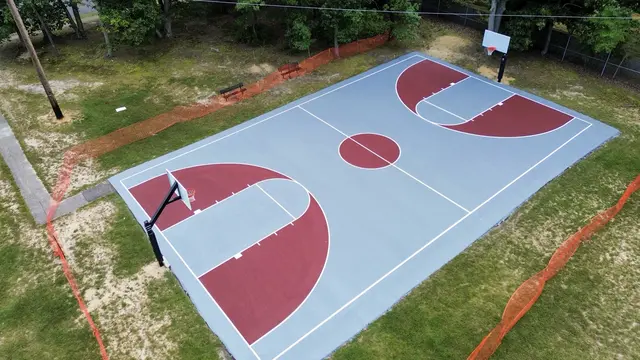 Angled view of the resurfaced basketball court at Flair Ridge Park