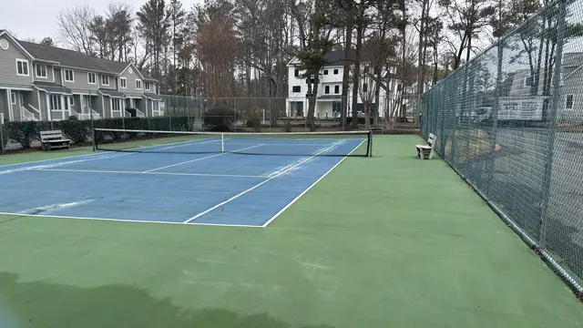 Schooner Village tennis court surface before renovation