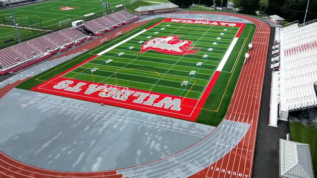 Stadium turf field surrounded by the running track and spectator bleachers
