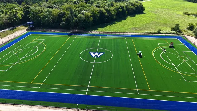 Aerial side view of Wilson College’s turf field and blue perimeter