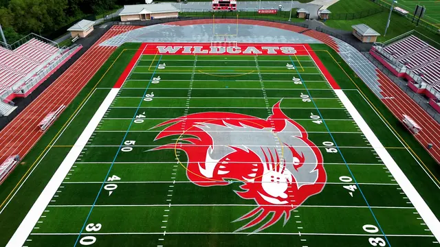Wildcat midfield logo, football lines and red WILDCATS endzone at the stadium